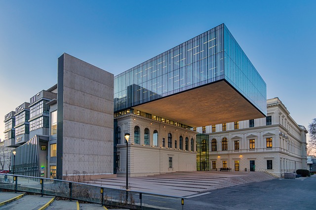 Edificio con diseño arquitectónico modernista, combinando elementos clásicos y contemporáneos, destacando la integración de vidrio y concreto