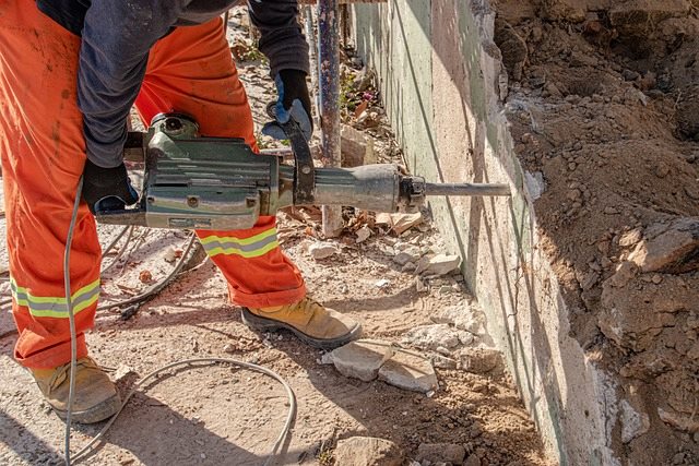 Trabajador en obre con un taladro para la construcción de casas.